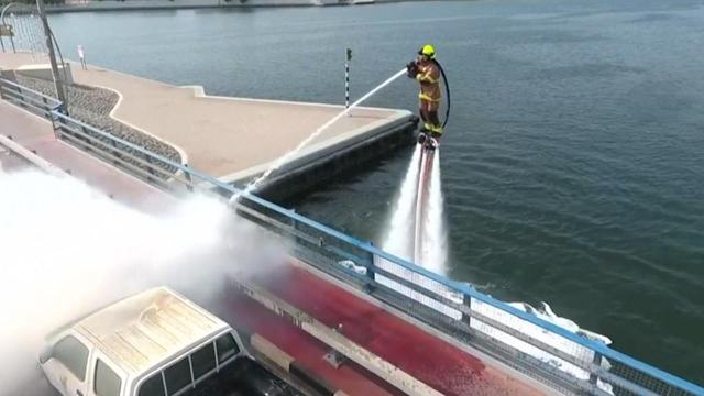 Watch: Firefighters use water jetpacks to put out flames